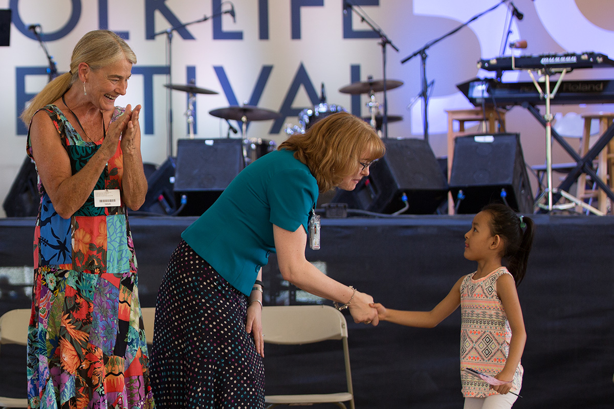 Sheila Kay Adams (left) and a representative from the U.S. Citizenship and Immigration Services congratulates a brand new American citizen. Photo by Daniel Martinez, Ralph Rinzler Folklife Archives