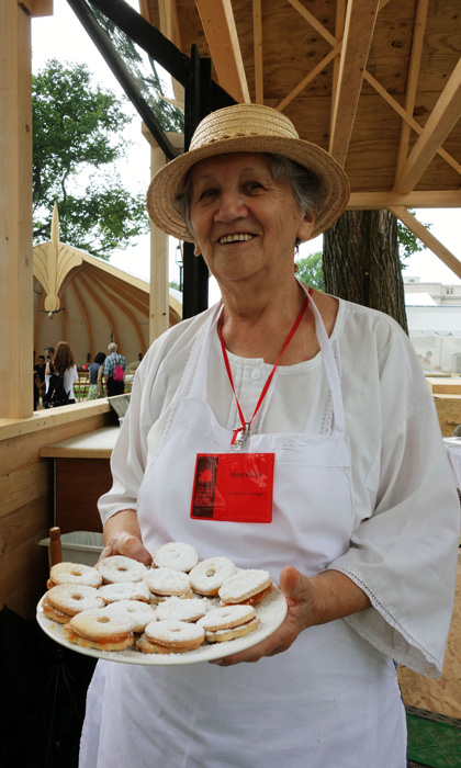 Ilona Kollár smiles as she offers vanilla wreaths with apricot jam. Photo by Lili A. Kocsis