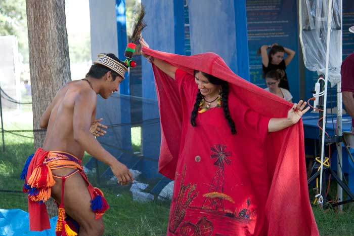 Wayuu dancer Marciano Urrariyú Gouriyu from Colombia and Festival presenter Maria Firmino-Castillo perform a traditional dance in the <i>One World, Many Voices</i> program area. Photo by Katherine Moore, Ralph Rinzler Folklife Archives