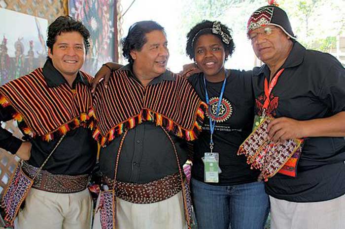 Arlean Dawes with three members of Los Masis—(L to R) Roberto Sahonero Cuéllar, Roberto Sahonero Gutiérrez, and Edgar Sahonero Gutiérrez—in the <i>One World, Many Voices</i> program. Los Masis is a group of Bolivian musicians and educators dedicated to preserving the Quechua language and indigenous Andean culture. Photo by Patti Heck