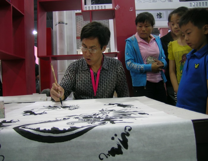 A brush painter demonstrates his work for children at an exposition in Taierzhuang, China.