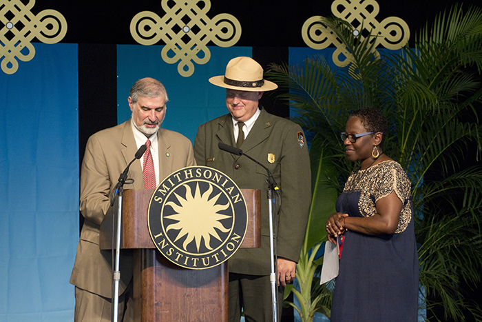 Richard Kurin (under secretary of History, Art, and Culture at the Smithsonian), Robert Vogel (superintendent of National Mall and Memorial Parks at the National Park Service), and Sabrina Motley (director of the Smithsonian Folklife Festival) prepare to sign a memorandum of understanding that ensures the Festival's future on the National Mall.