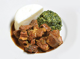Goat stew with spinach and ugali. Photo by and courtesy of Swahili Village