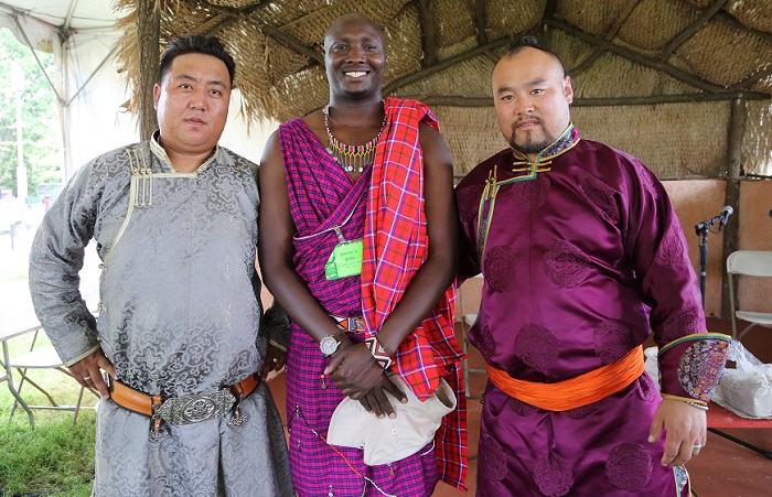 Alatenggaridi, Stephen S. Moiko, and Dabuxilatu pose for a photo after a cross-program on herding culture at the Boma Stage.