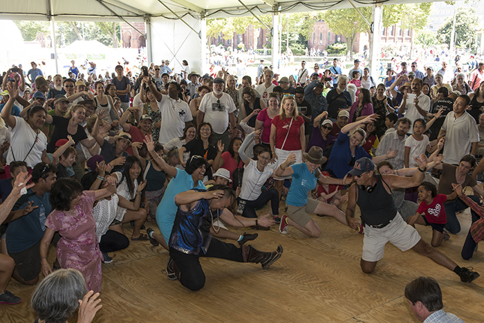 Festival visitors dance with Ih Tsetsn singer and qobuz player Dabuxilatu during a performance at the Moonrise Pavilion.