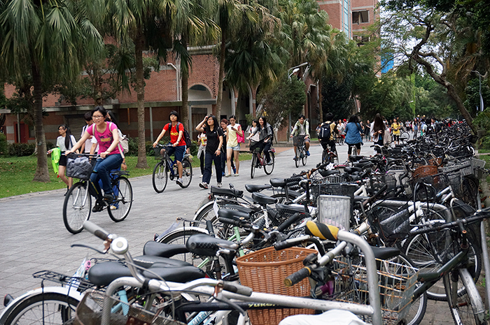 Students pass by a bike rack at the National Taiwan University in Taipei, which is known to be a bike-friendly campus.