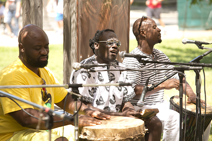 Joseck Asikoye, Justo Asikoye, and Makadem perform together on the Karibuni stage. Photo by Pruitt Allen, Ralph Rinzler Folklife Archives and Collections, Smithsonian Institution