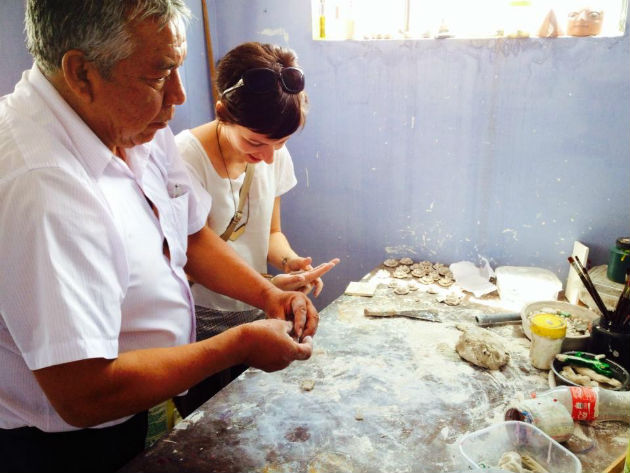 Alfredo Lopez Morales teaching Marketplace coordinator Jackie Flanagan Pangelinan how to sculpt “clay” flowers in Ayacucho, Peru. Photo by Colvin English, Ralph Rinzler Folklife Archives 