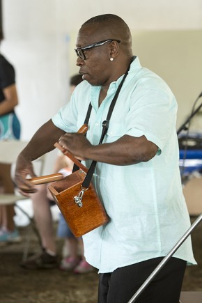 As part of Festival Community Day, Freddy "Huevito" Lobotón demonstrated how to play the cajita, a percussion instrument inspired by church collected boxes. Photo by Micheal Barnes, Ralph Rinzler Folklife Archives