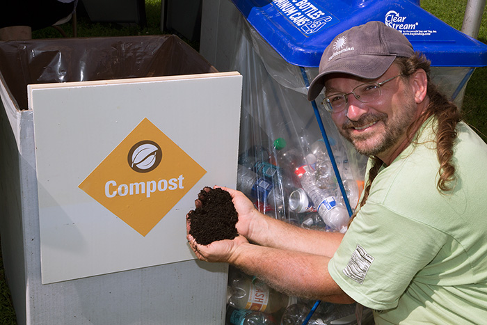 Eric Hollinger shows off a handful of compost, easily produced from food waste. Photo by Francisco Guerra, Ralph Rinzler Folklife Archives