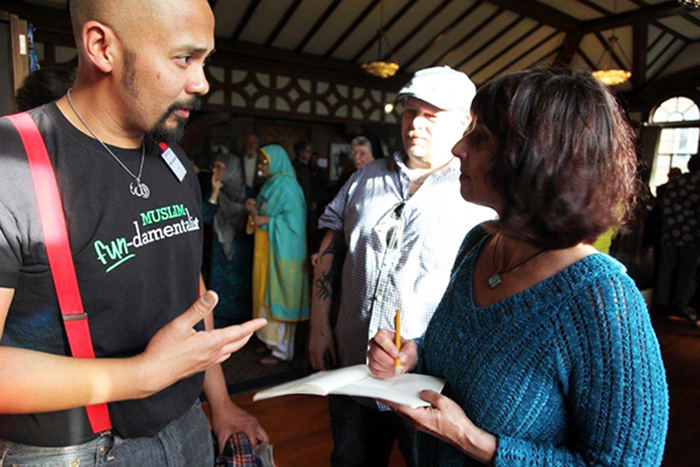 ACTA program manager Lily Kharrazi (right) talks with an artist at the Islamic Cultural Center of Northern California’s 2013 <em>Calligraphies in Conversation</em> exhibit in Oakland, funded in part by ACTA’s Living Cultures Grants Program. Photo by Kutay Kugay, courtesy of the Alliance for California Traditional Arts