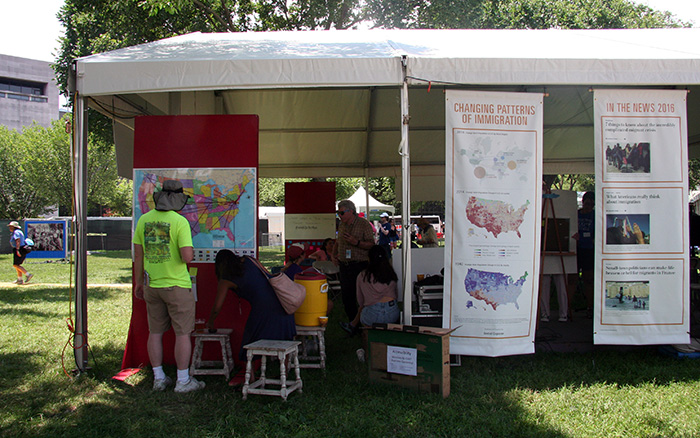 The <em>On the Move</em> tent at the Folklife Festival displays Social Explorer's maps of U.S. immigration patterns. Photo by Elisa Hough