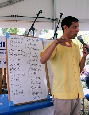 Quetzal Flores helps collect words from the audience. Photo by Ying Diao srcset=