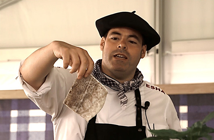 Chef Igor Ozamiz Goiriena shows the crowd a loin of salt cod that has been soaked and rehydrated in cold water. Ralph Rinzler Folklife Archives
